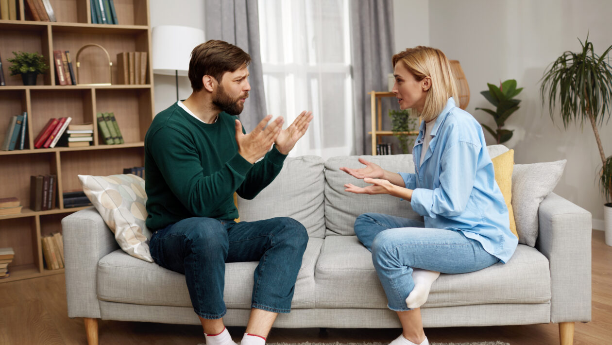 Couple sitting on the couch Having Argument At Home