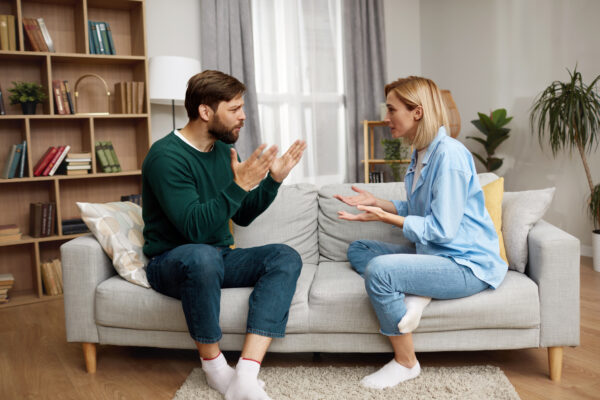 Couple sitting on the couch Having Argument At Home